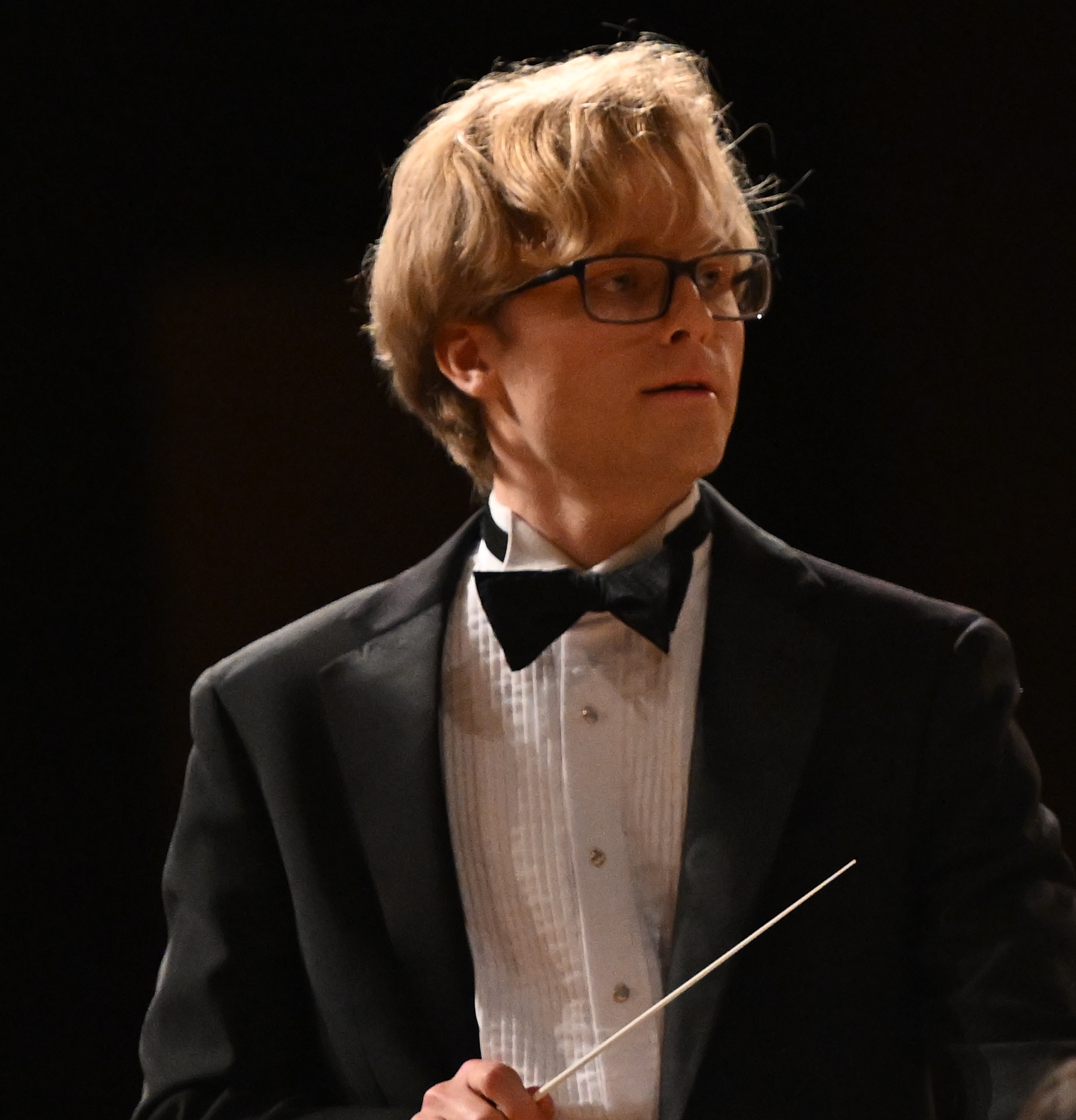 Close portrait of Caleb Thompson with baton