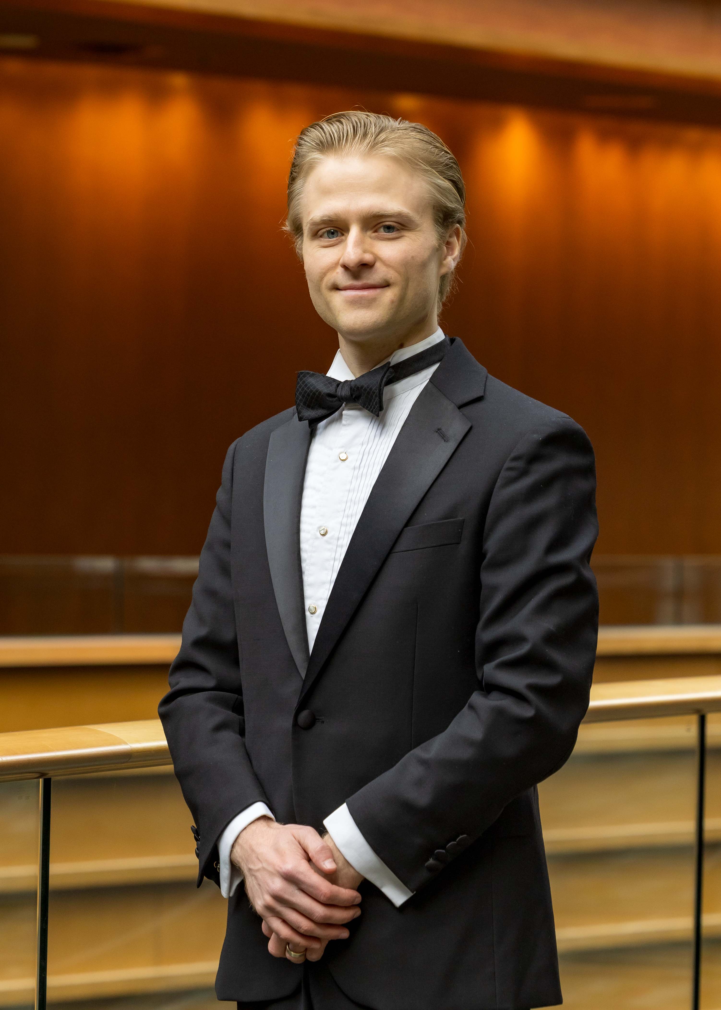Portrait of Caleb Thompson in a concert hall